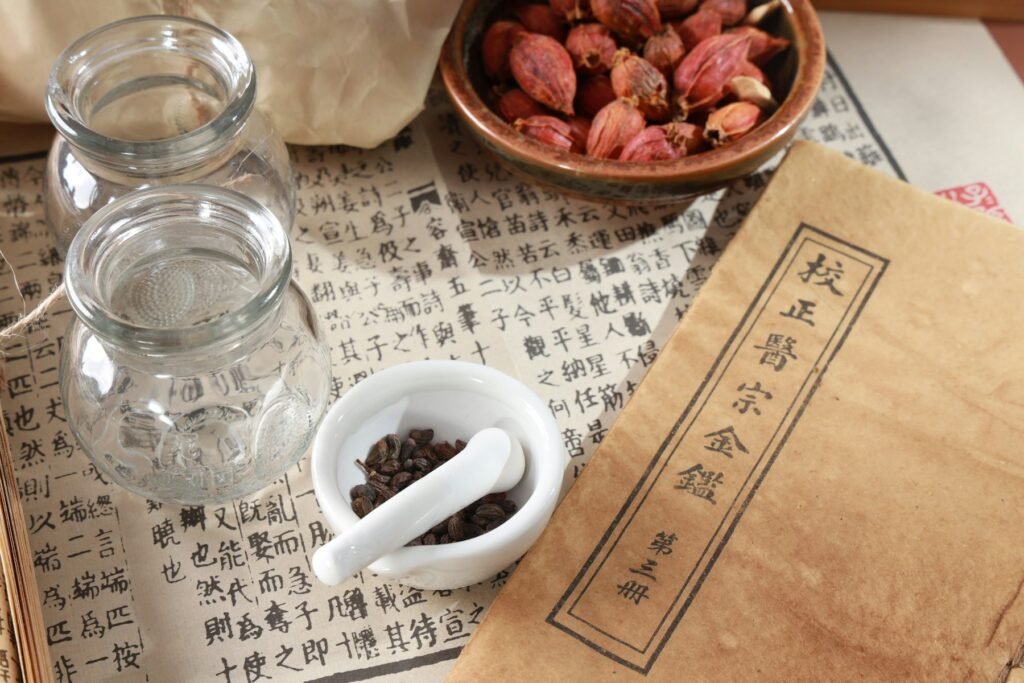 A cup of herbal tea and a glass jar of dried herbs on the shop counter